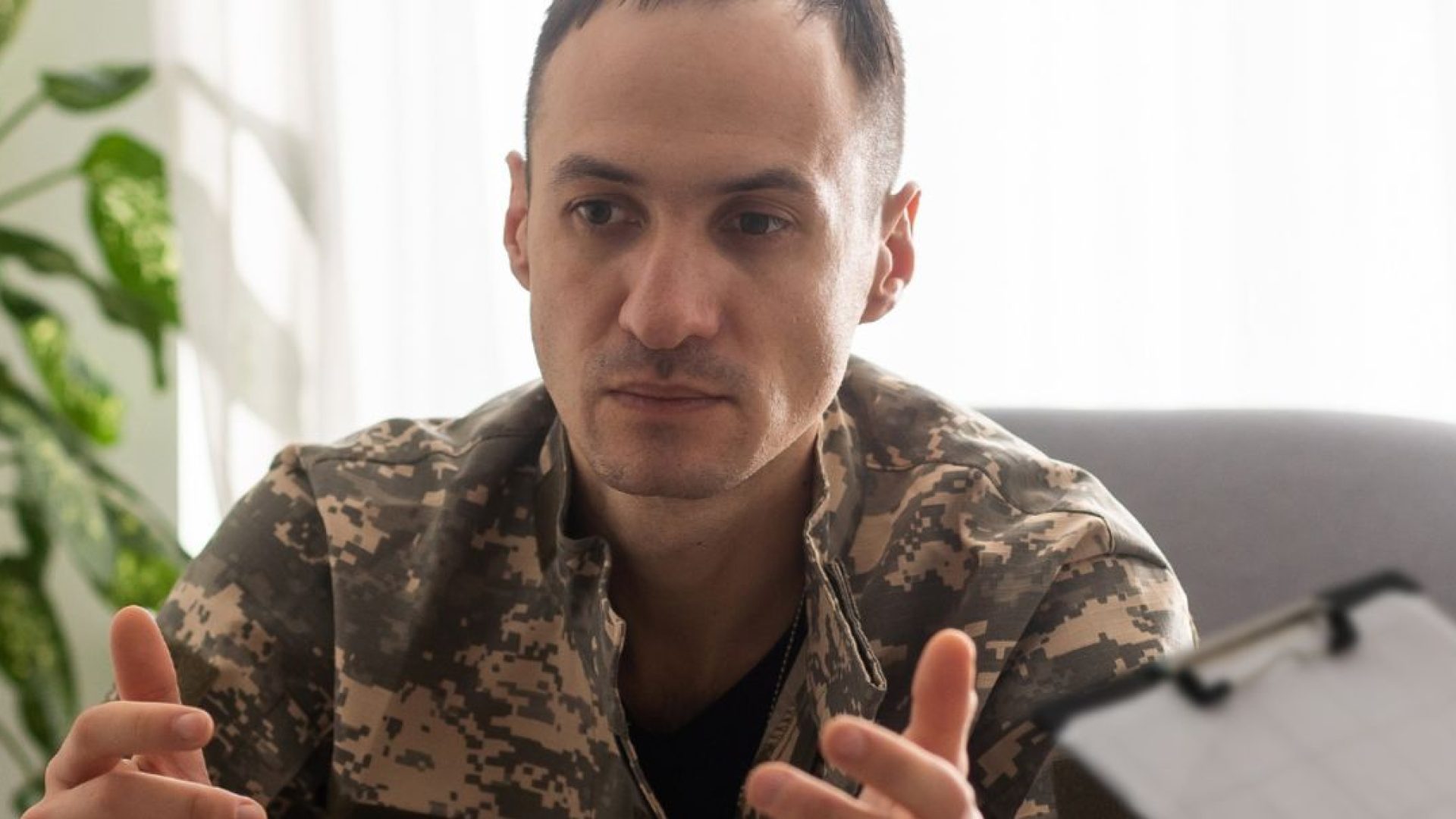 A veteran discussing something with therapist, with large, agitated hand movements.