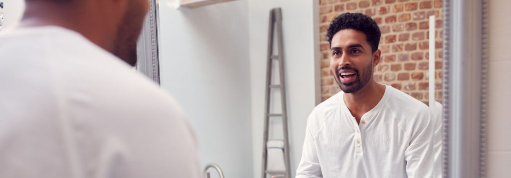 Person looking into the mirror, engaging in dialectical behavior therapy.