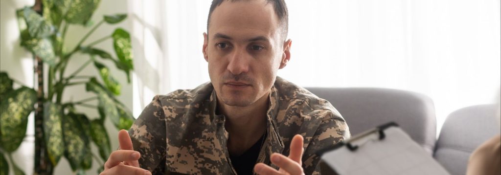 A veteran discussing something with therapist, with large, agitated hand movements.